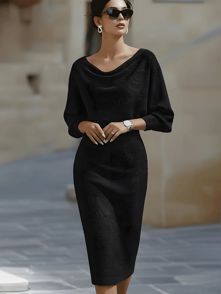 Side view of cowl neck midi dress showing relaxed batwing sleeves and fitted skirt silhouette