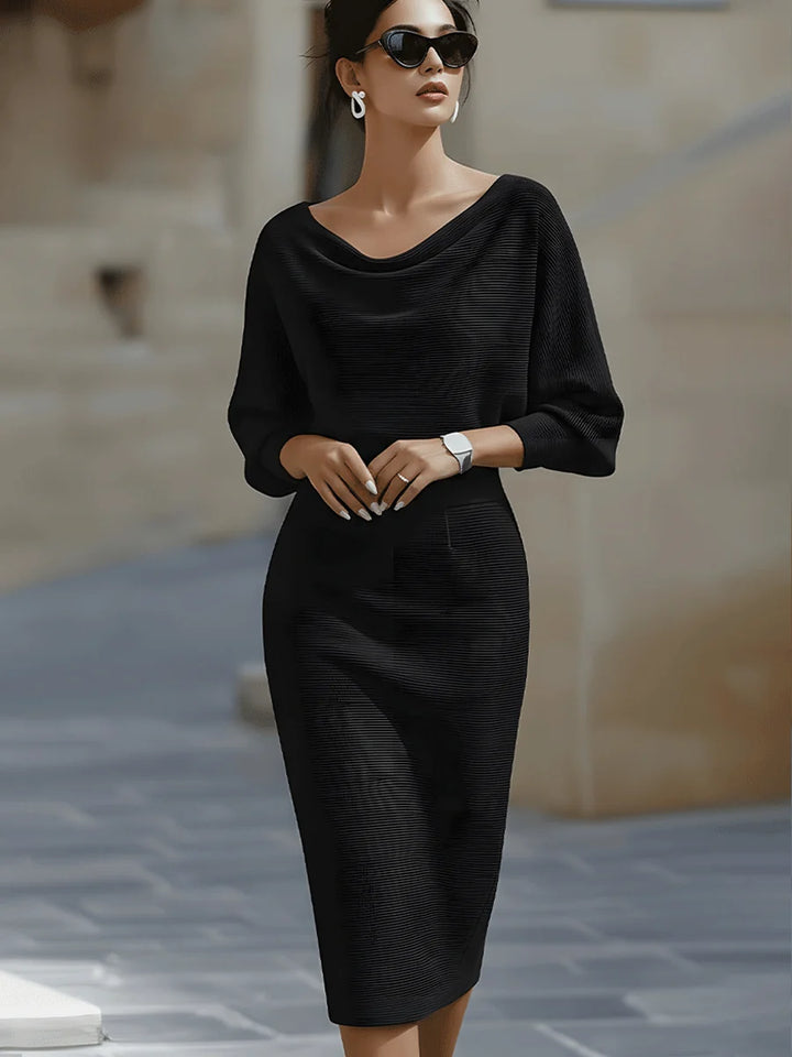 Side view of cowl neck midi dress showing relaxed batwing sleeves and fitted skirt silhouette