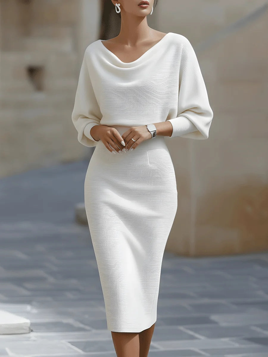 Back view of navy blue ribbed knit midi dress with draped cowl neckline and tapered hem