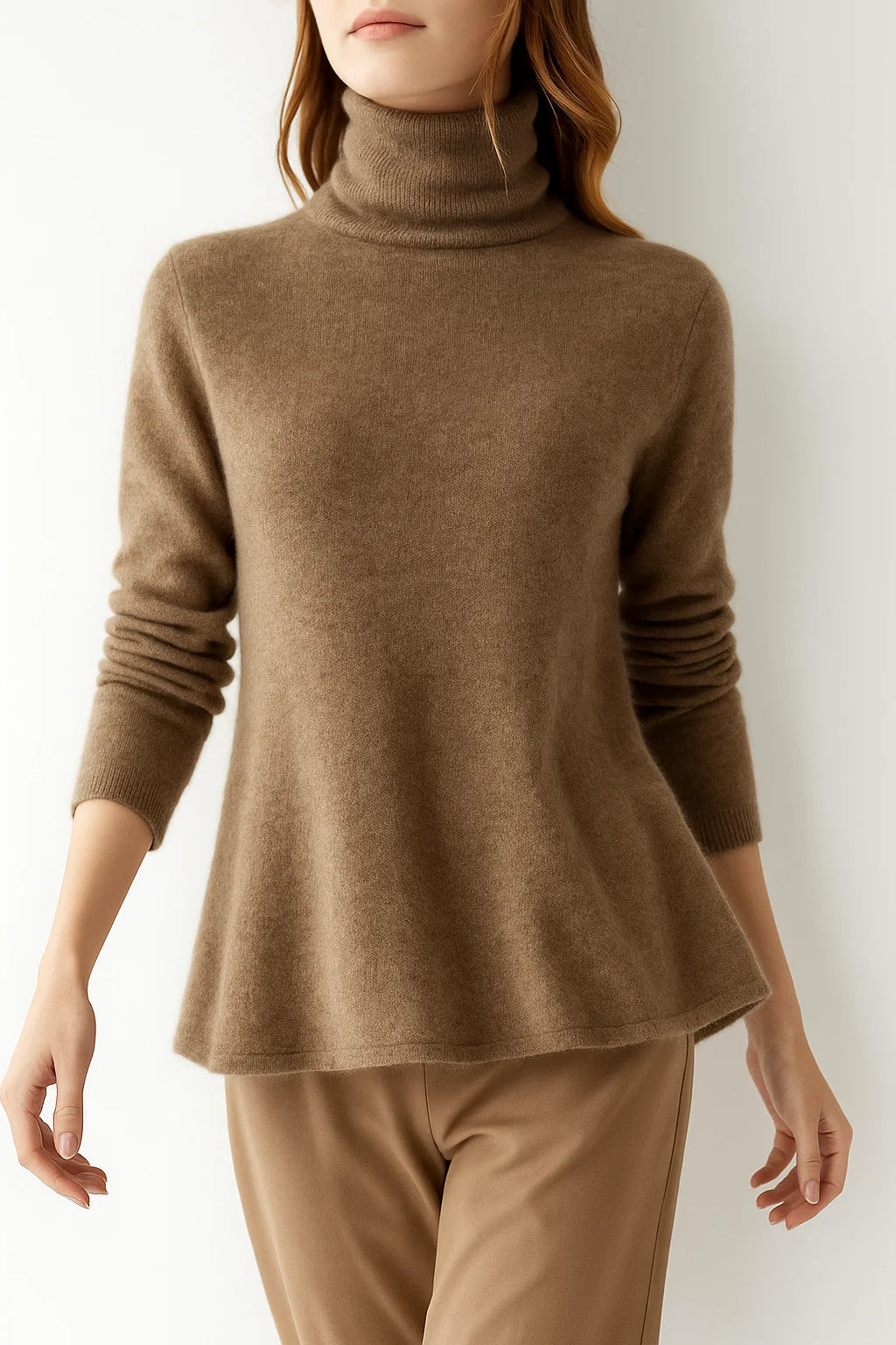 Full view of women's cashmere turtleneck styled with neutral trousers for a coordinated autumn outfit