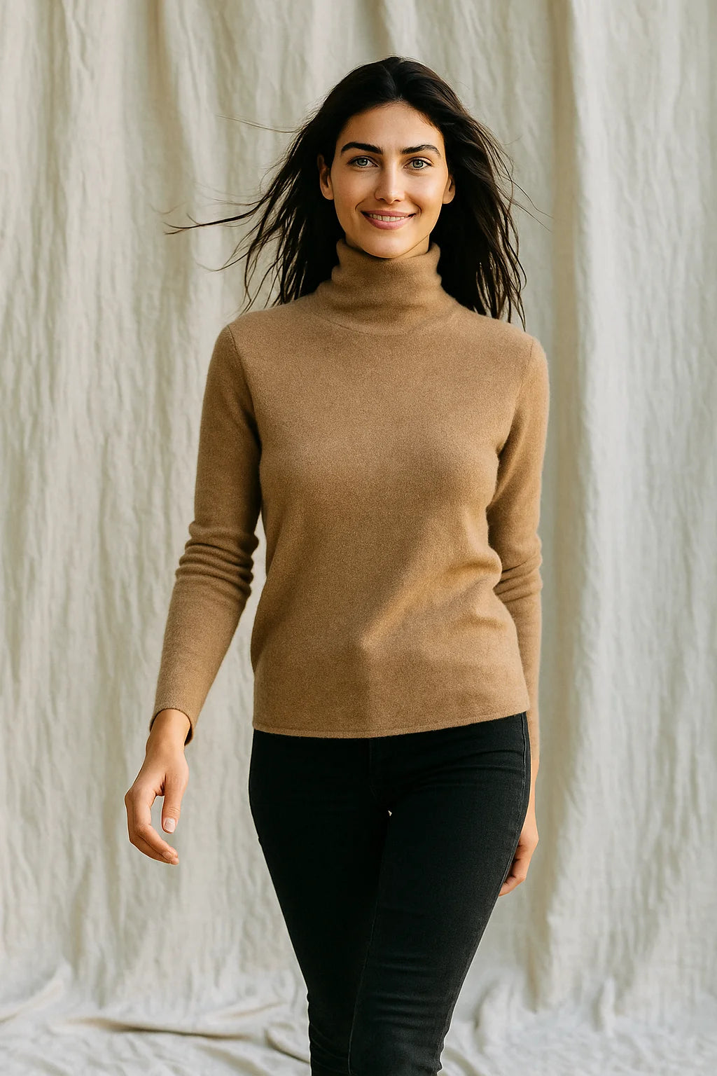Three-quarter view of a cashmere turtleneck on a model, showing the versatile layering piece in neutral tones