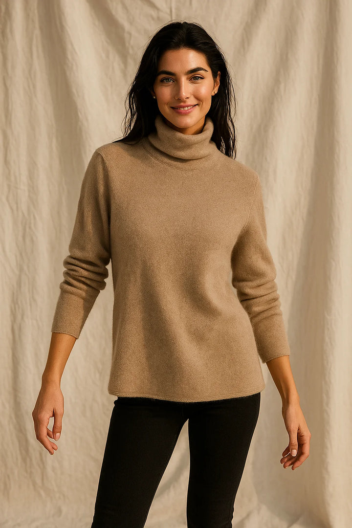 Detail of the smooth fabric texture and ribbed hem on a women's cashmere turtleneck jumper