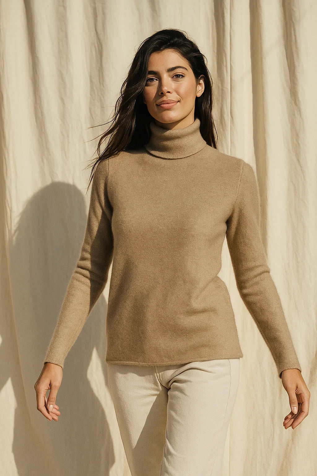 Woman styling a cashmere turtleneck with tailored trousers, demonstrating the versatile silhouette