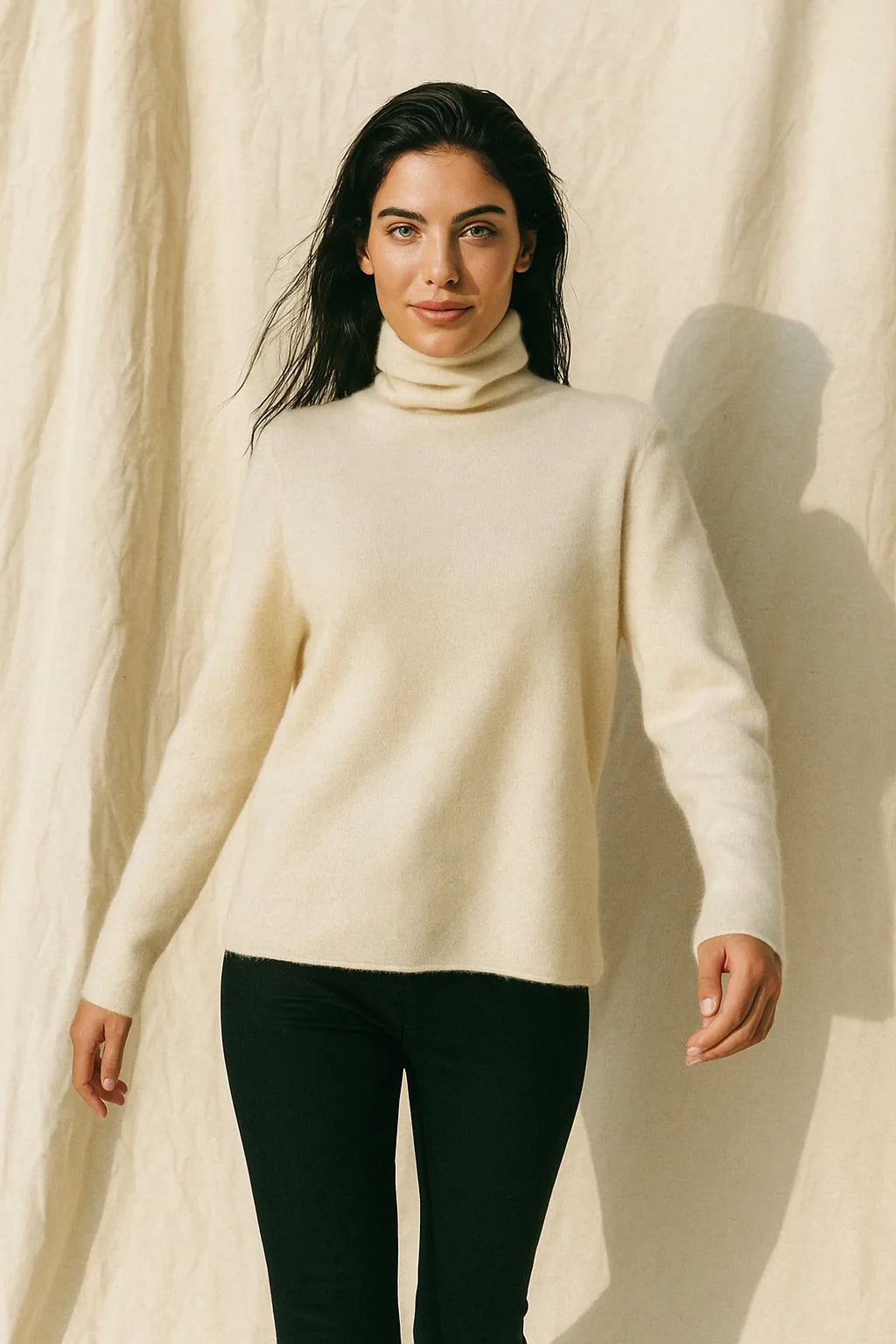 Three-quarter angle of a cashmere turtleneck on a model, highlighting the smooth finish and drape