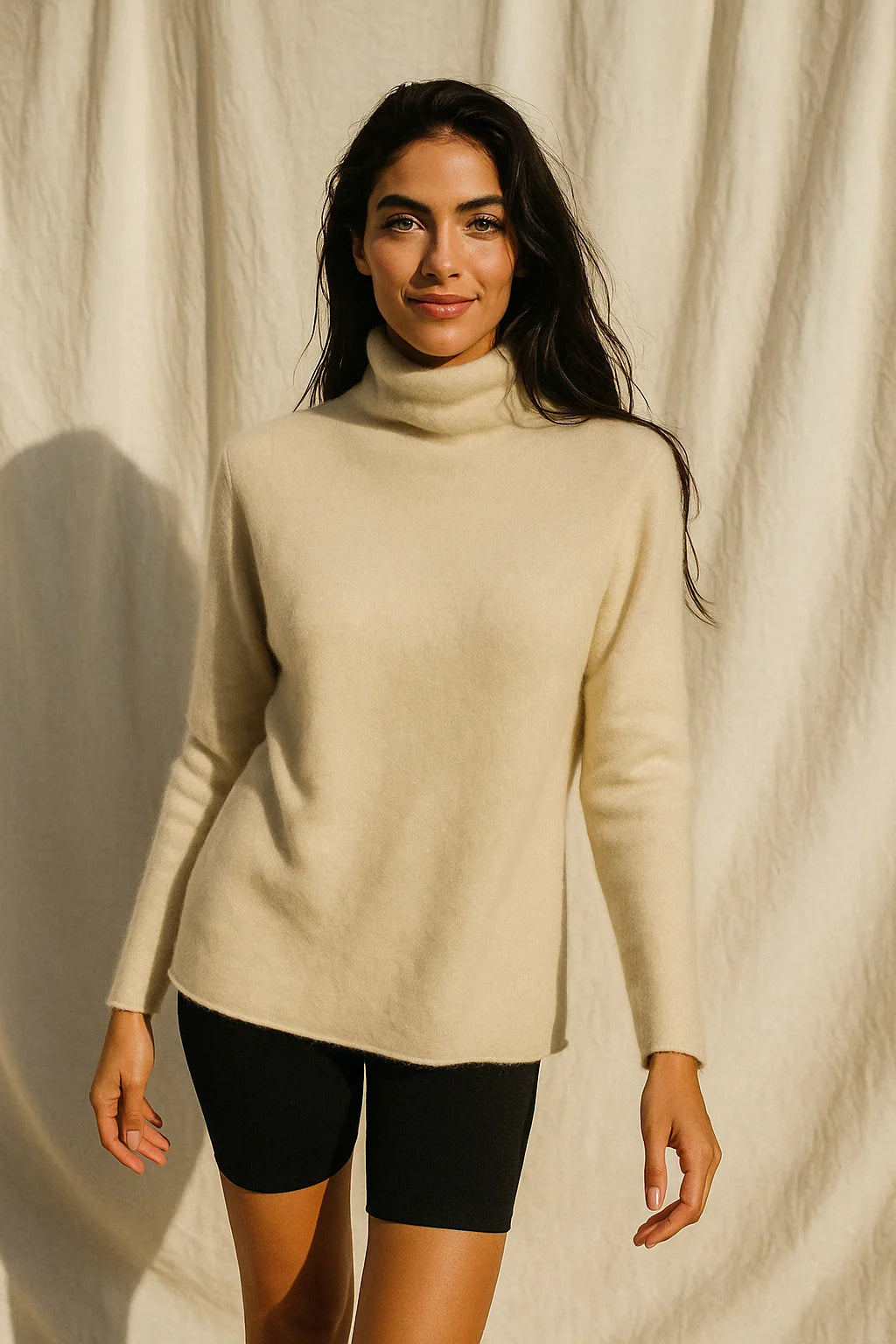 Woman in a taupe cashmere turtleneck with a relaxed silhouette, ideal for layering or standalone wear