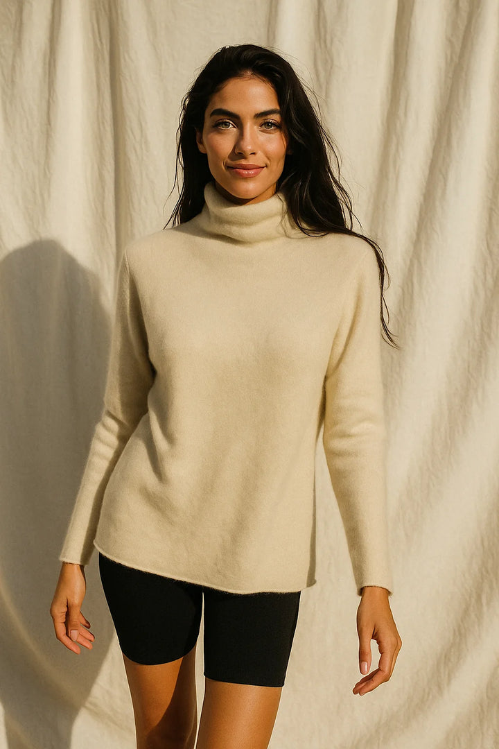 Woman in a taupe cashmere turtleneck with a relaxed silhouette, ideal for layering or standalone wear