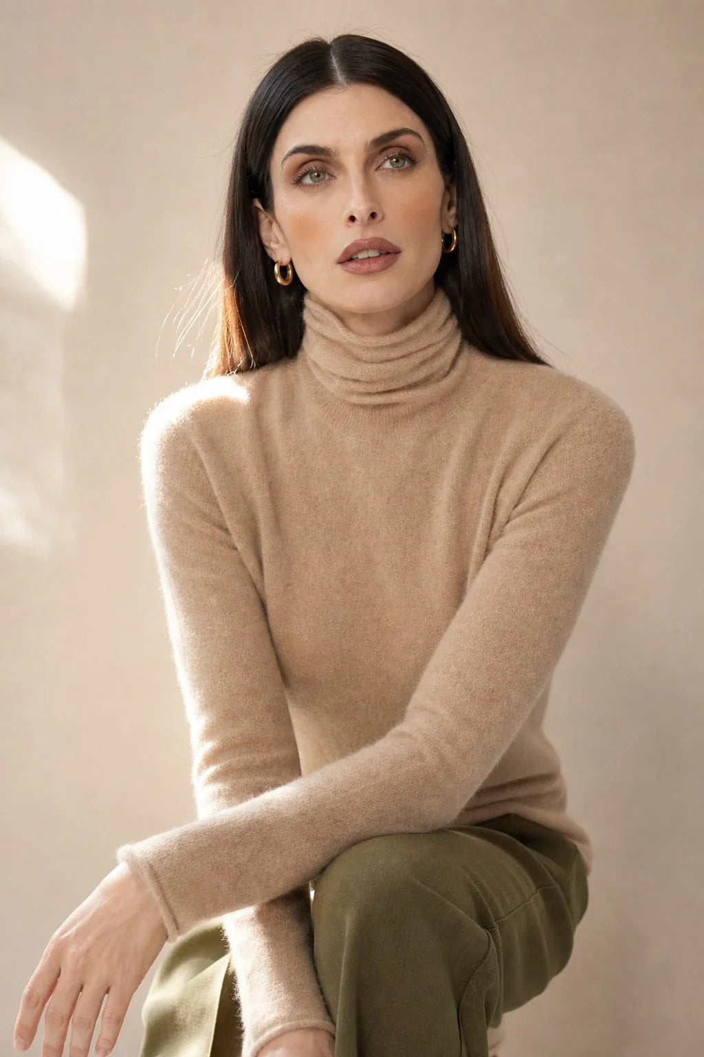 Back view of women's cashmere turtleneck showing the relaxed fit through the torso and ribbed hem detail