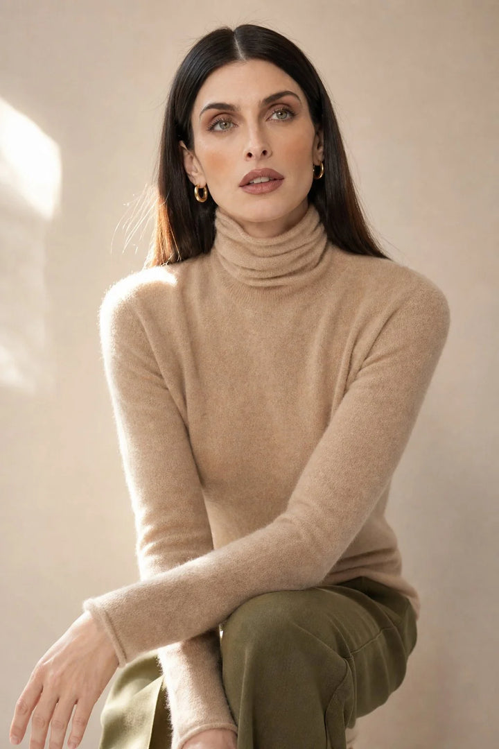 Back view of women's cashmere turtleneck showing the relaxed fit through the torso and ribbed hem detail
