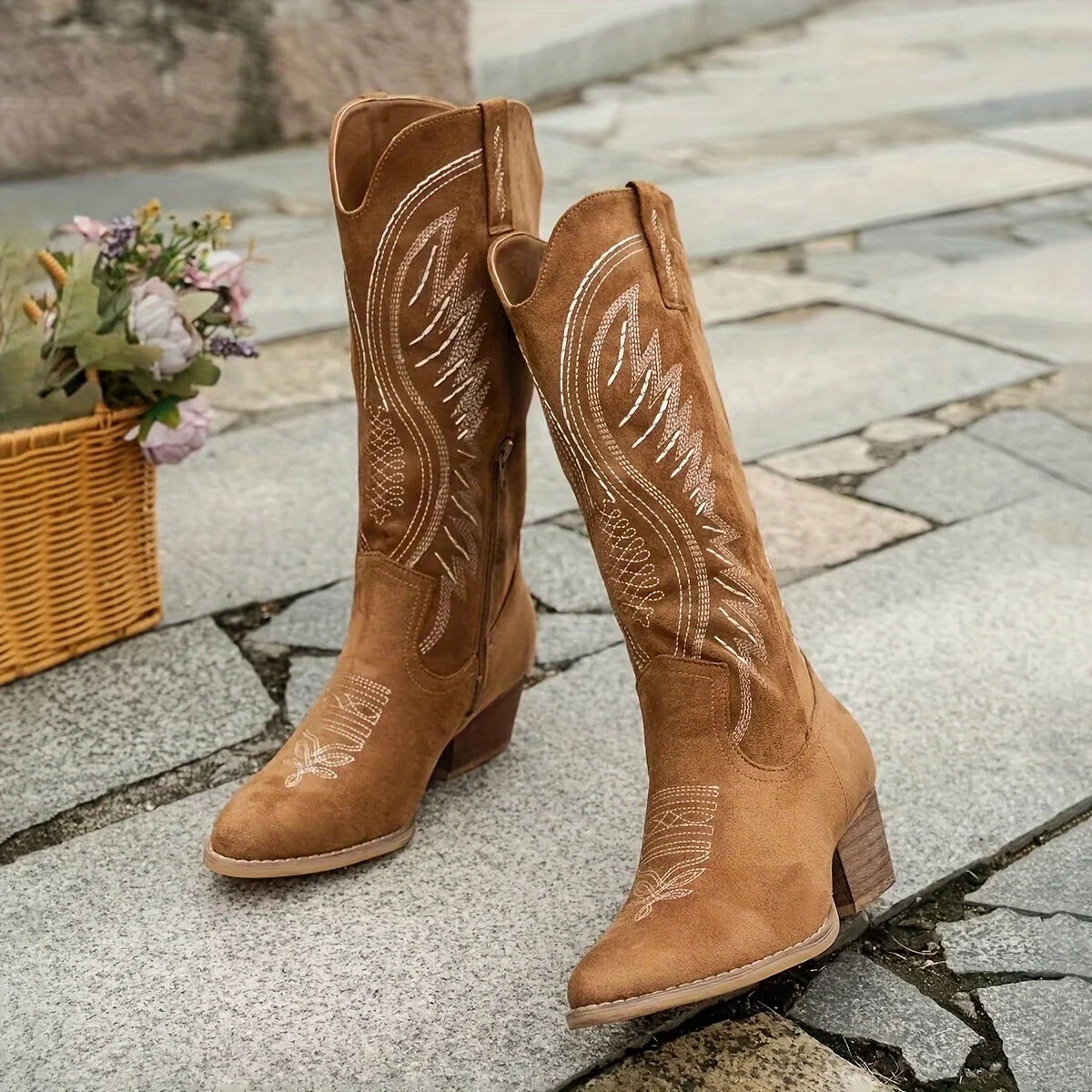 Side view of women's tan cowboy boots with block heel and decorative embroidery