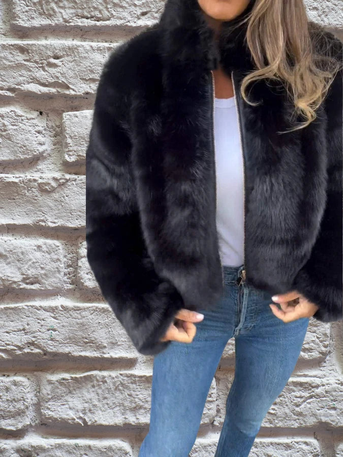 Close-up view of plush faux fur texture on women's cropped bomber jacket