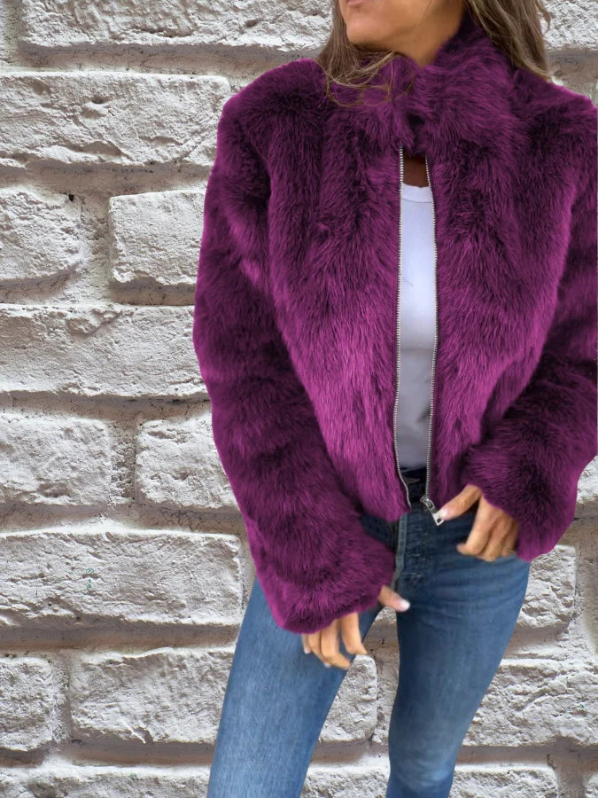 Detail of zip closure and high stand collar on women's faux fur bomber jacket