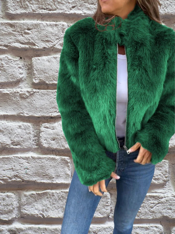 Women's faux fur bomber jacket styled with white top and denim for casual autumn look