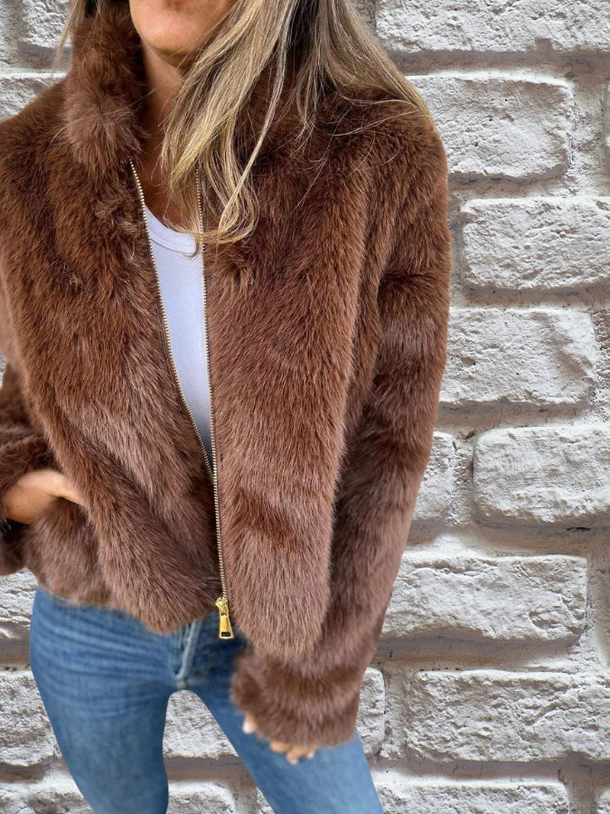Full-length view of women's brown faux fur bomber jacket paired with casual outfit