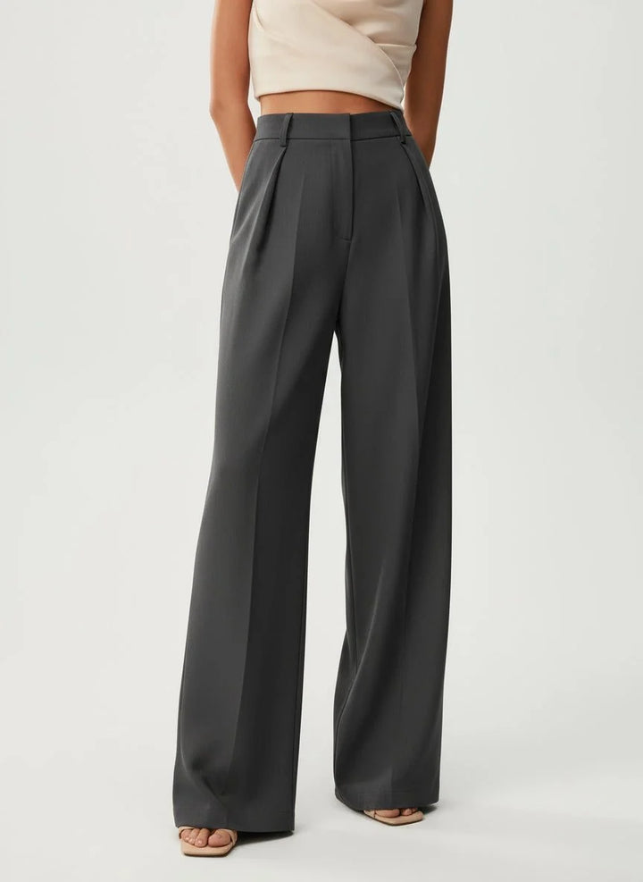 Women's tailored high waist trousers in camel with wide leg and relaxed fit shown from back