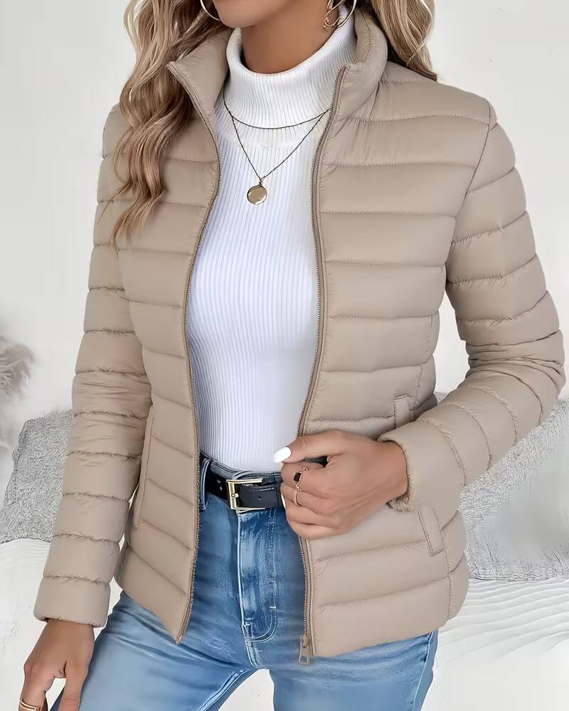 Mint green quilted puffer jacket showing stand collar detail and smooth outer shell with horizontal stitching