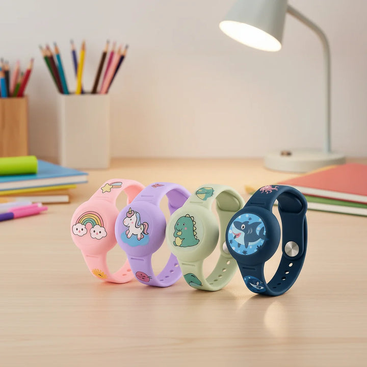 Children's GPS tracking wristband in pink, purple, green, and navy with character designs on a desk