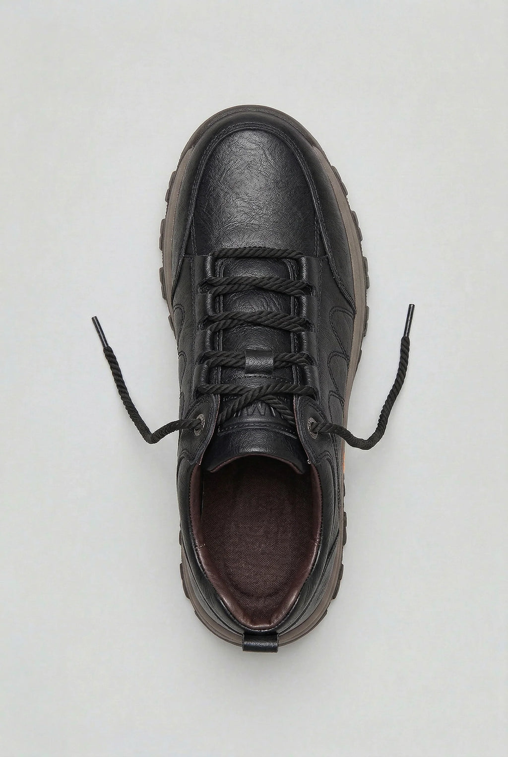Close-up of men's cushioned walking shoes highlighting deep tread outsole and padded collar detail