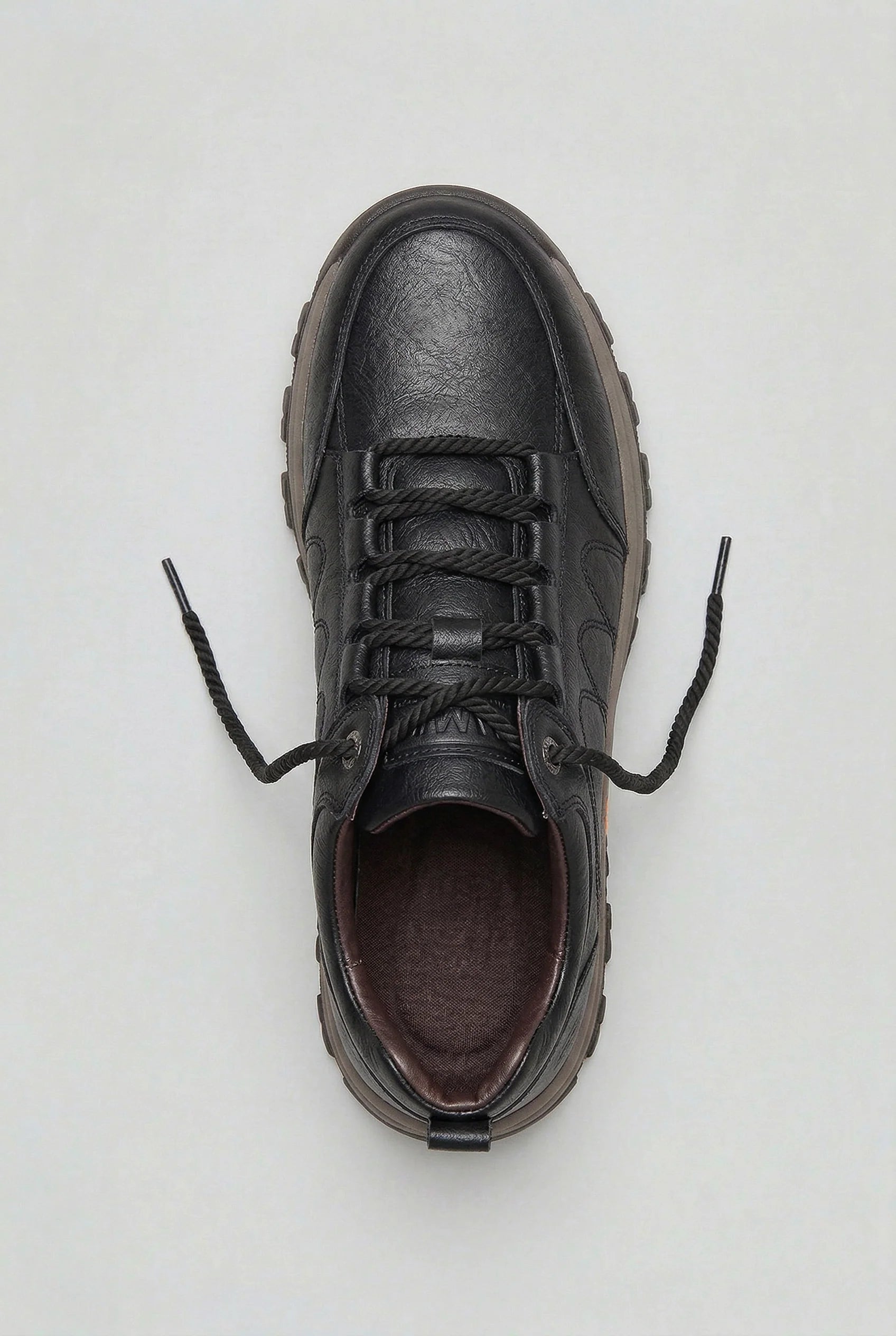 Close-up of men's cushioned walking shoes highlighting deep tread outsole and padded collar detail