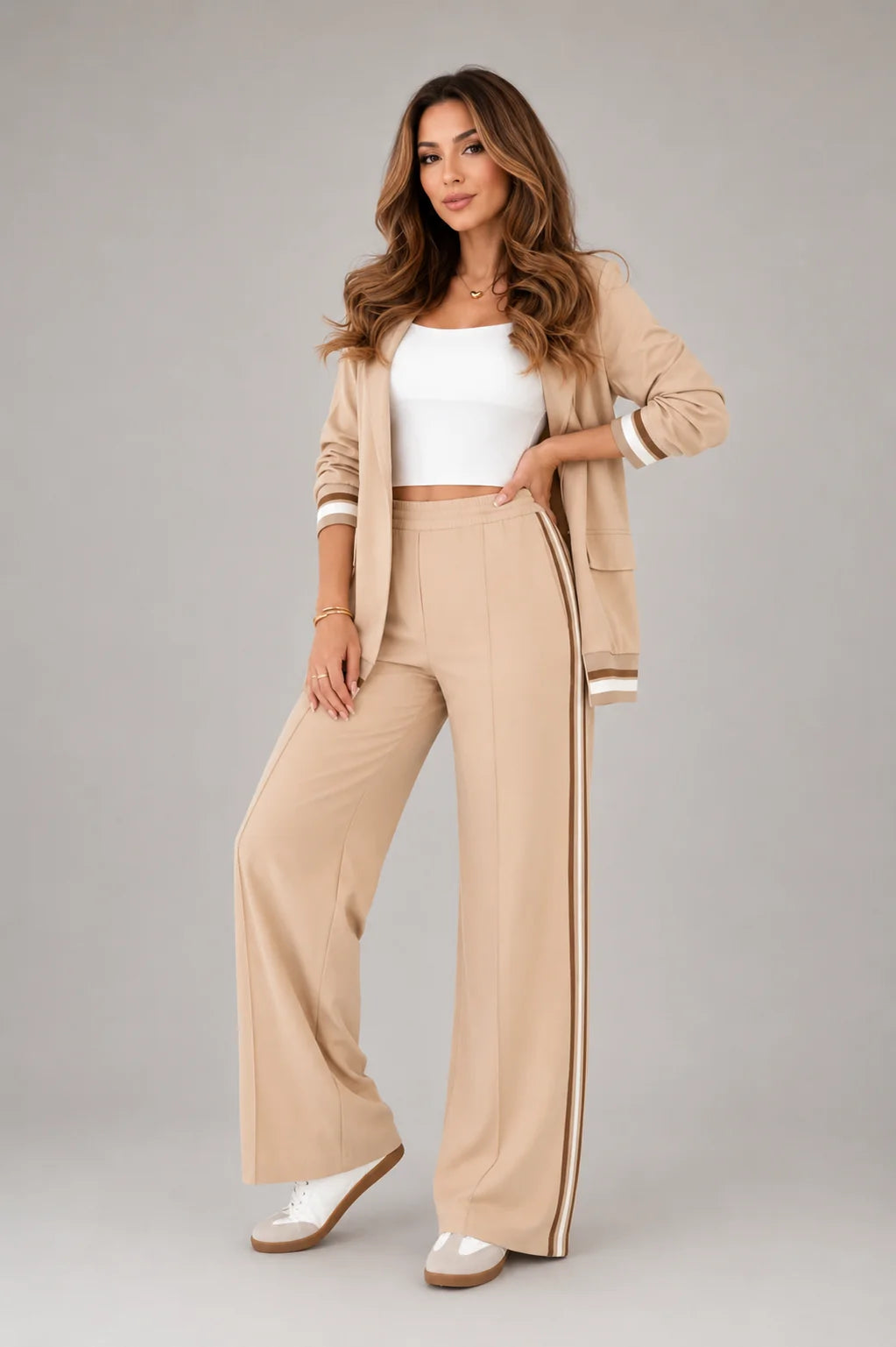 Full-length view of light blue two-piece suit set styled with white trainers for smart casual look