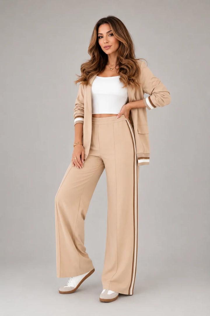 Full-length view of light blue two-piece suit set styled with white trainers for smart casual look