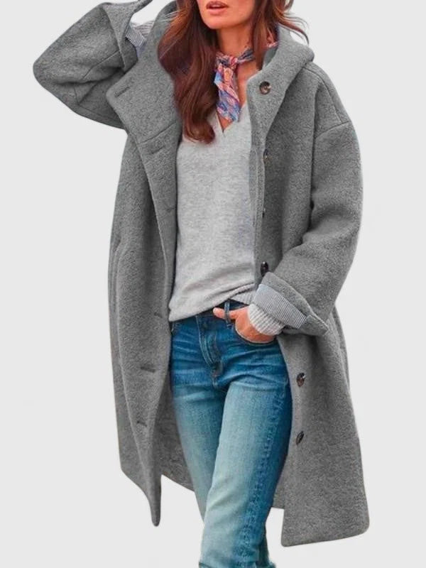 Side view of women's pink bouclé coat showing mid-length cut and deep side pockets