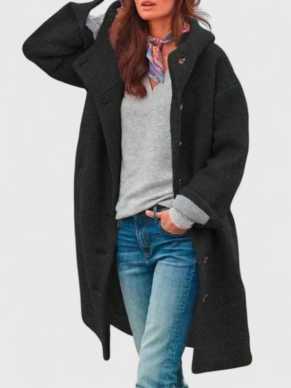 Close-up of women's hooded bouclé coat featuring textured fabric and contrasting button details