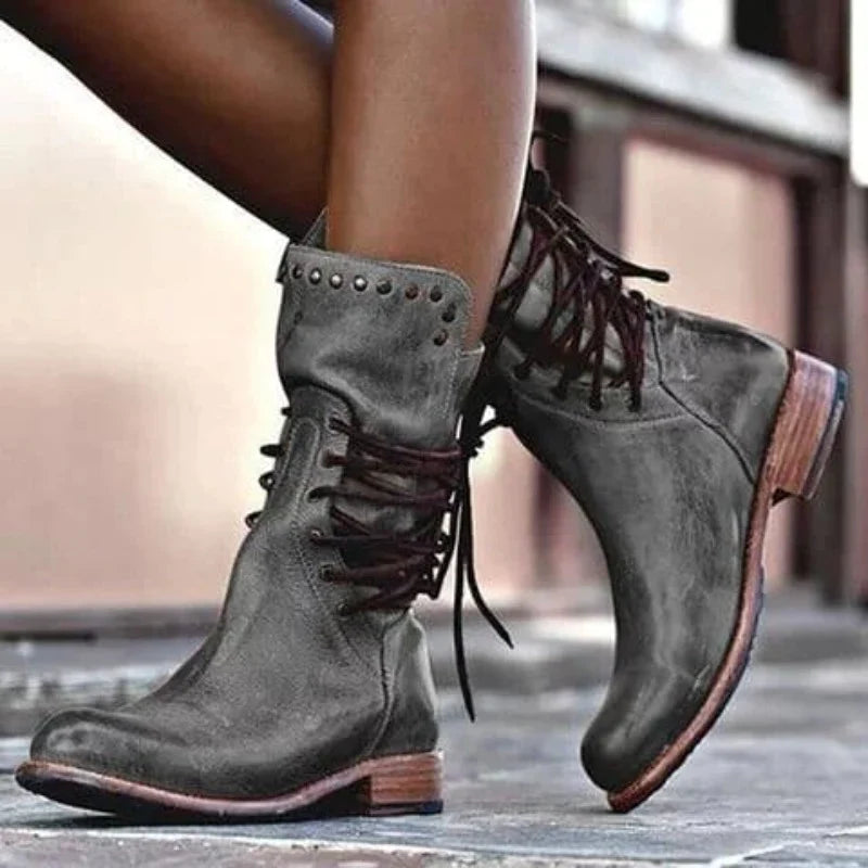 Women's lace-up ankle boots in grey with studded collar and block heel on pavement