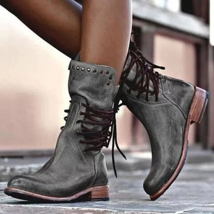 Women's lace-up ankle boots in grey with studded collar and block heel on pavement