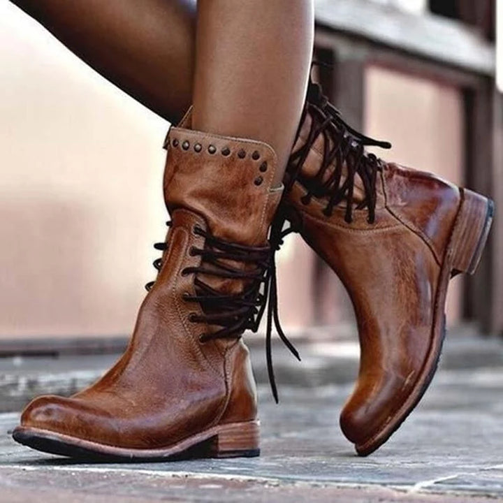 Side view of women's ankle boots with full lace-up closure and low block heel
