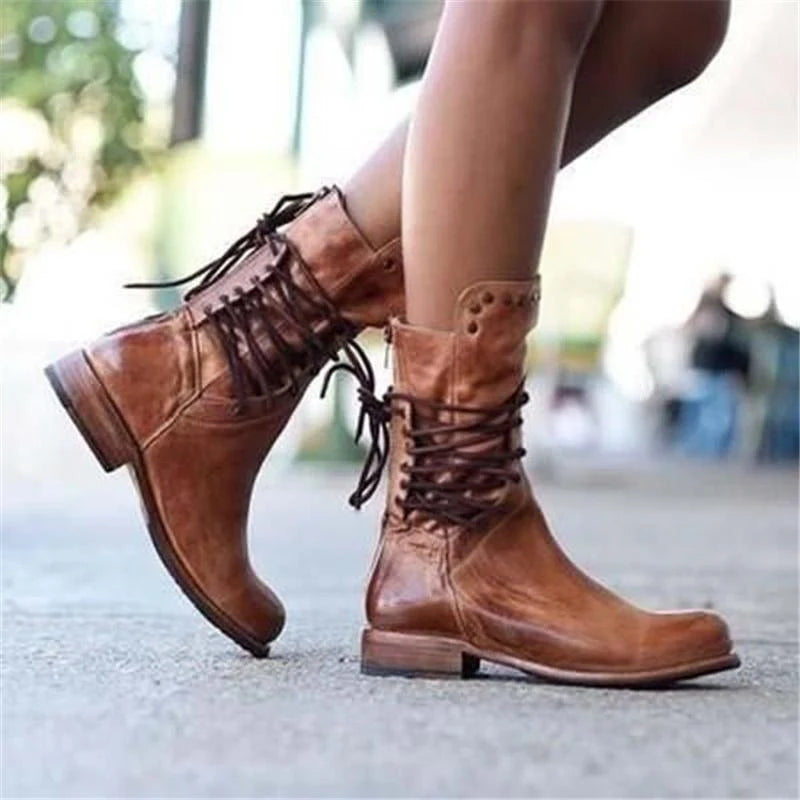 Detail of studded collar trim on grey lace-up ankle boots with rounded toe