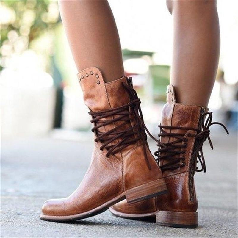 Full view of women's lace-up ankle boots displaying structured leather-look finish and studded detail