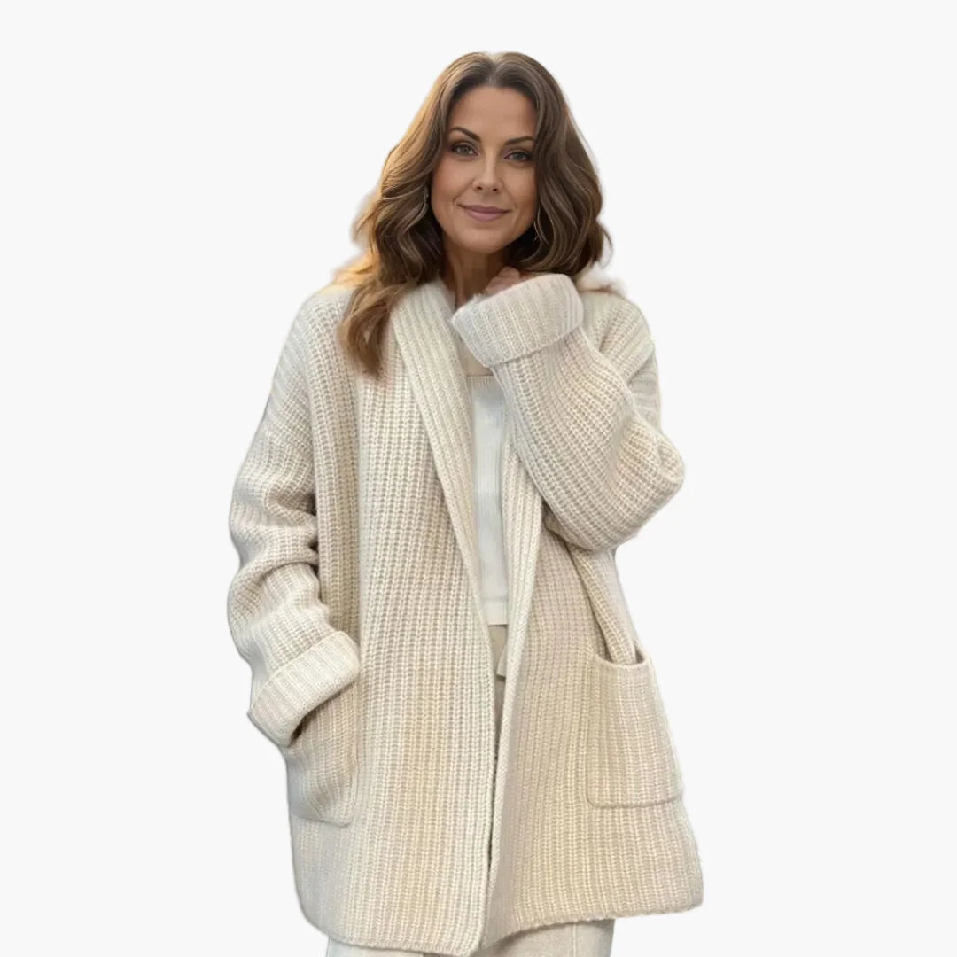Woman wearing an oversized knit cardigan in cream with open front and shawl collar
