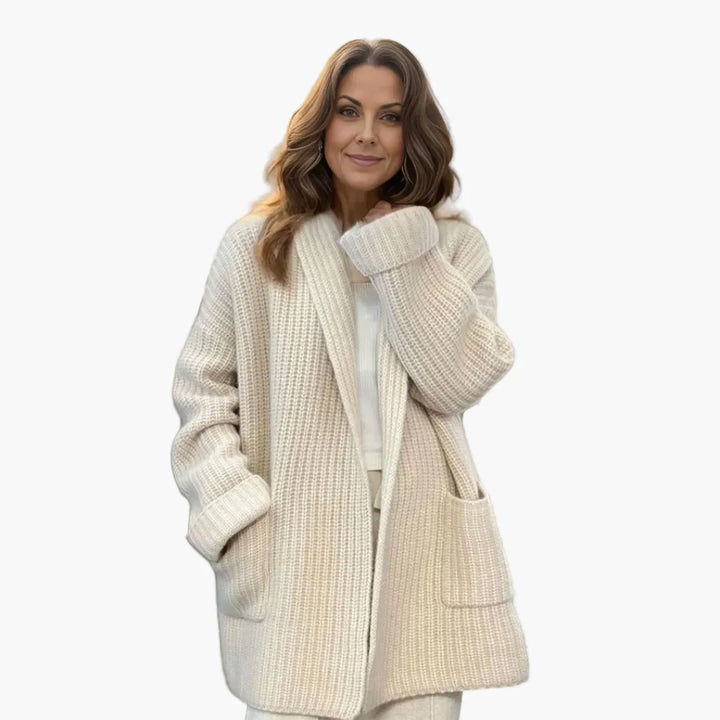 Woman wearing an oversized knit cardigan in cream with open front and shawl collar