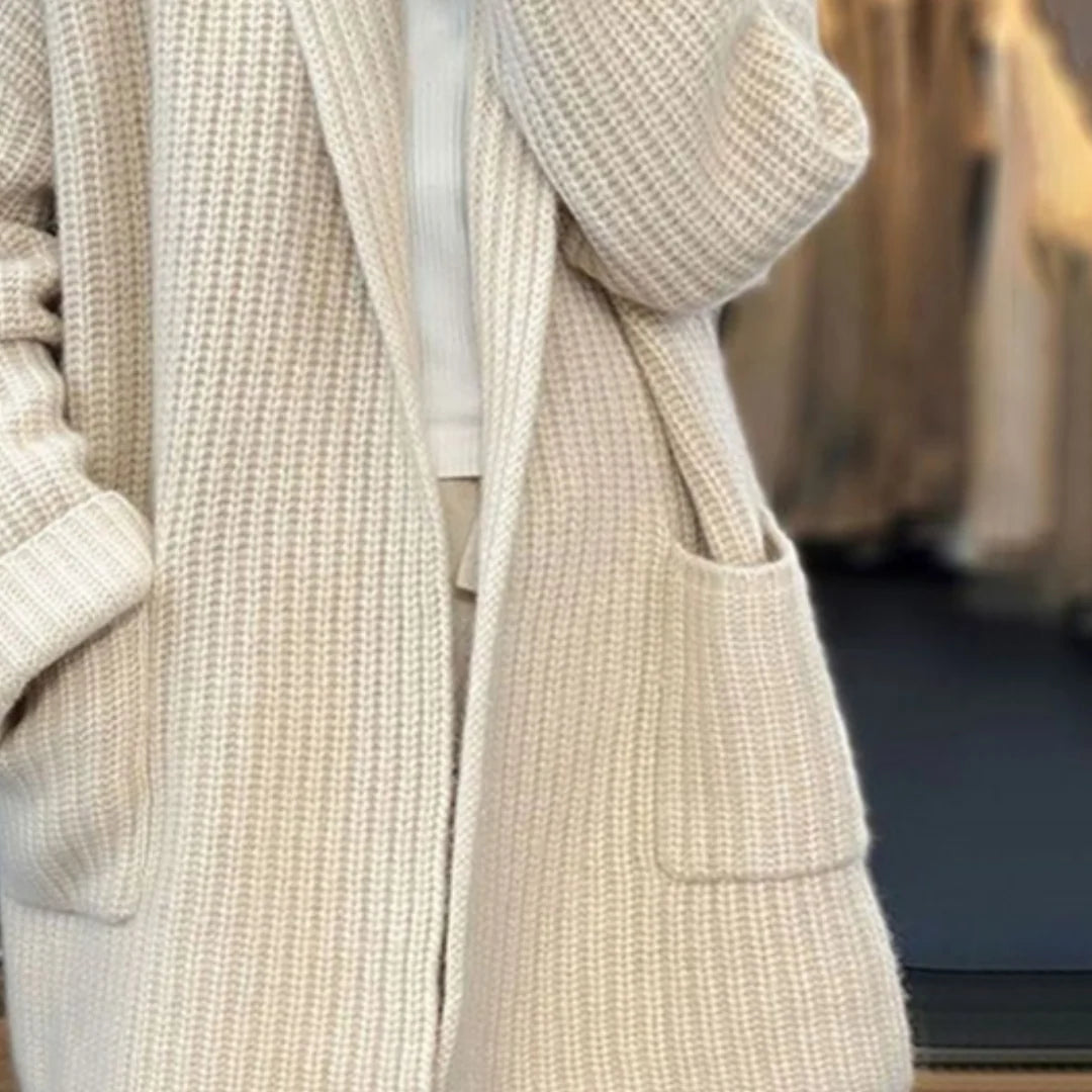 Side view of oversized knit cardigan with drop-shoulder sleeves and turned-back cuffs