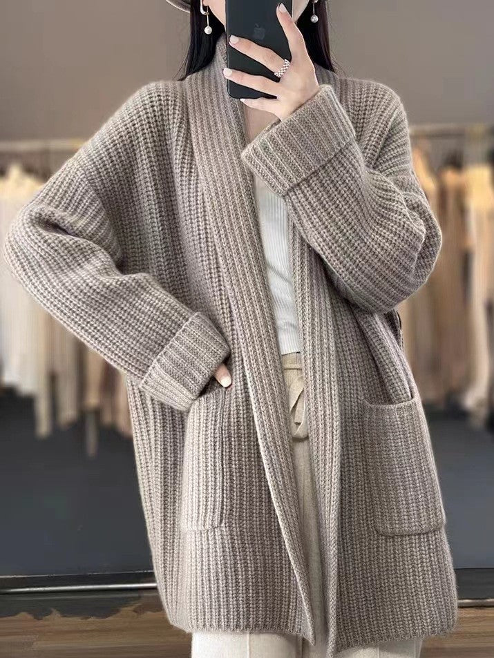 Detail of oversized knit cardigan front pockets and chunky ribbed knit construction