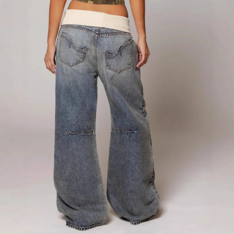 Close-up of baggy jeans waistband featuring classic button-zip fly and mid-rise construction with belt loops
