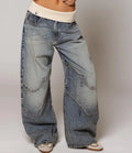 Detail shot of vintage light wash denim fabric showing structured drape and authentic faded finish