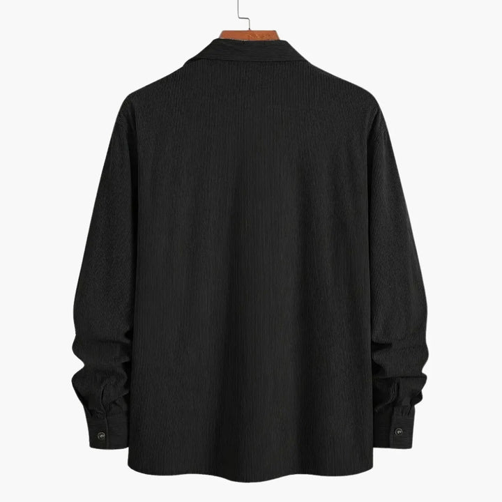 Men's corduroy shirt jacket showing textured fabric and dual chest pocket design