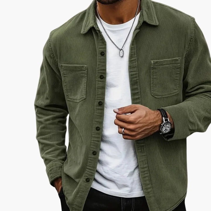 Close-up of men's blue corduroy shirt jacket showing textured ribbed fabric and button detail