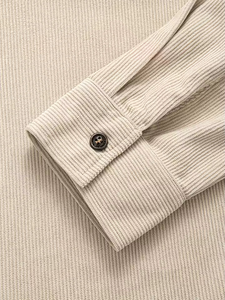 Full view of men's corduroy shirt jacket in blue with relaxed fit and ribbed texture