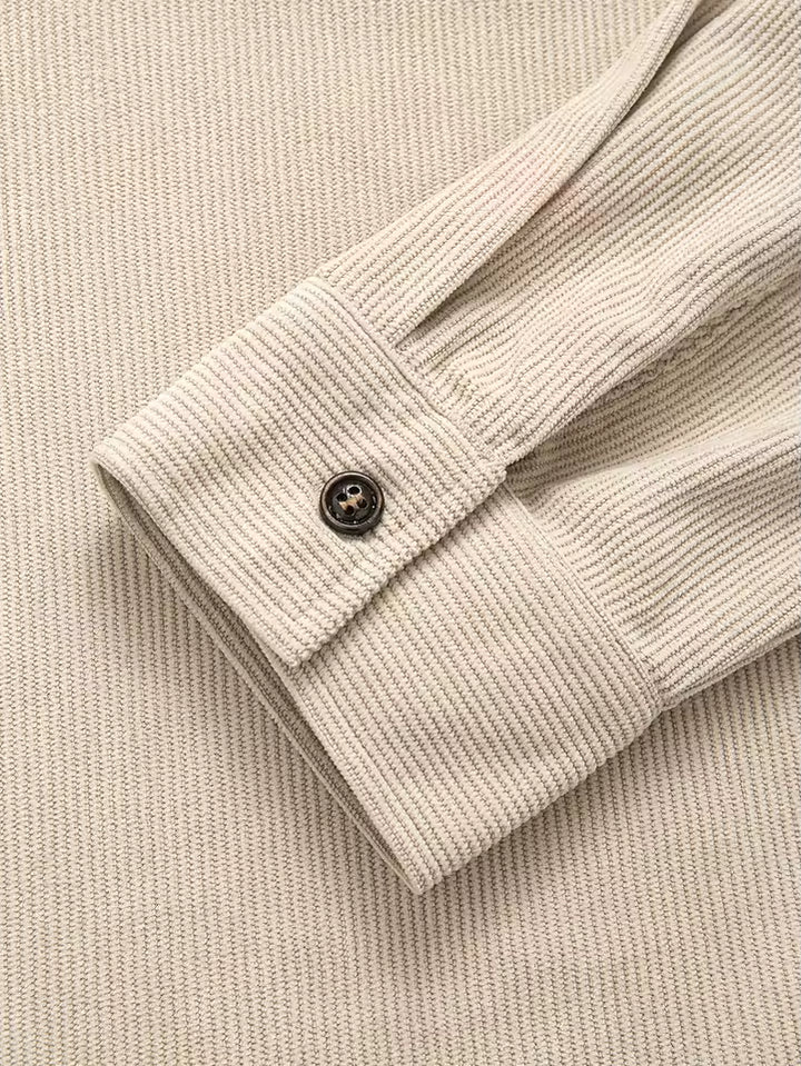 Full view of men's corduroy shirt jacket in blue with relaxed fit and ribbed texture