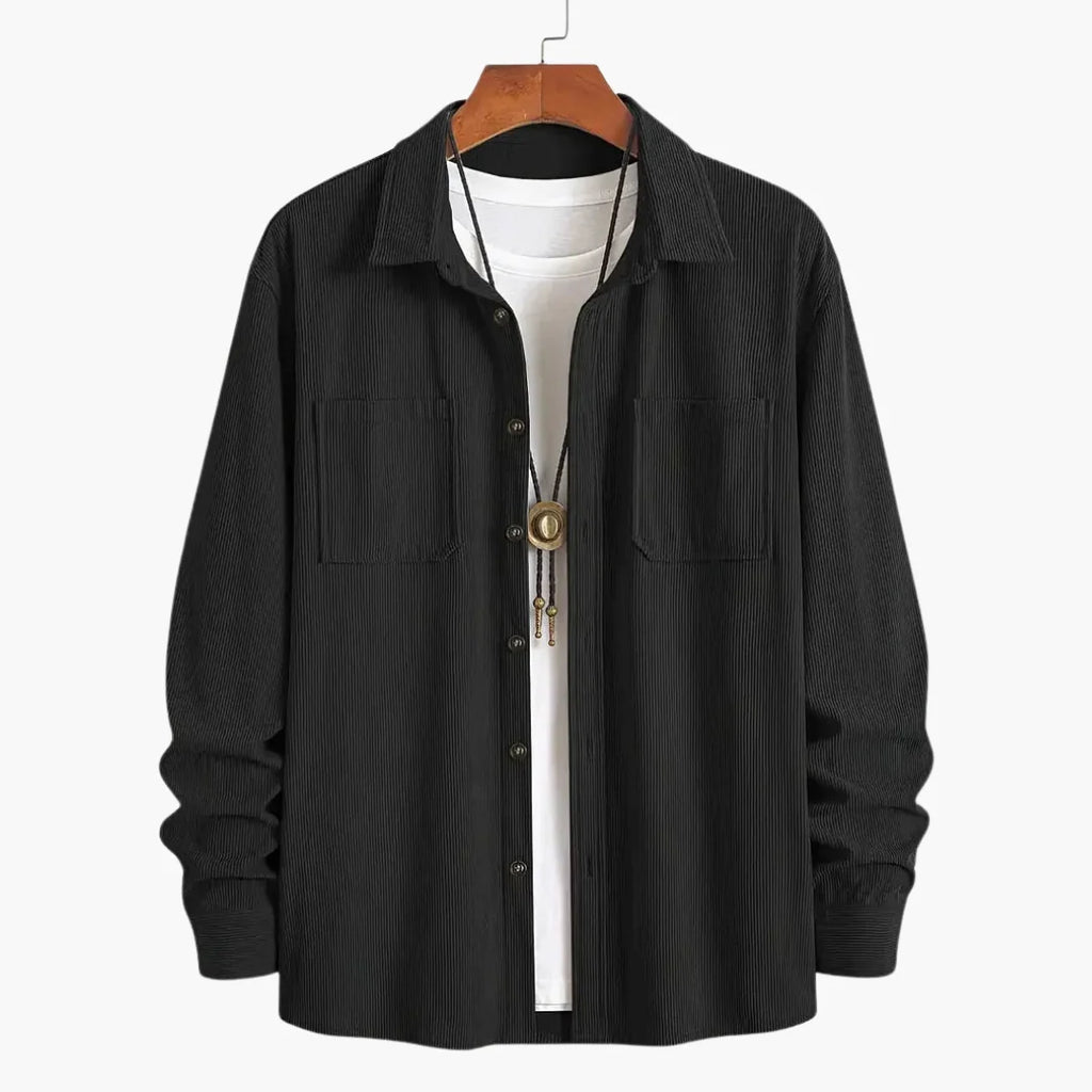 Men's blue corduroy shirt jacket worn open over white tee for casual layering