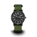 Men's military field watch with black dial, luminous markers, and olive green NATO strap on white background