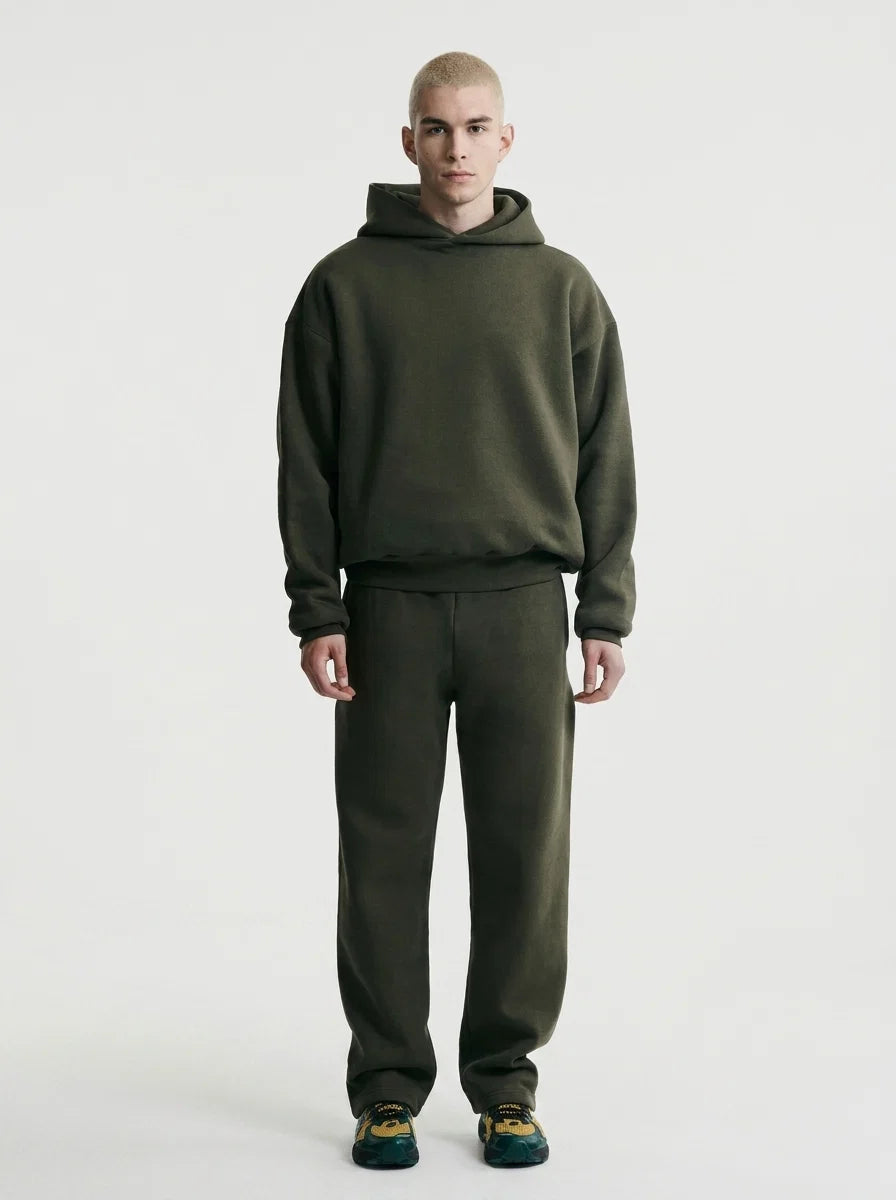 Men's oversized tracksuit in olive green with hooded pullover and matching joggers on model