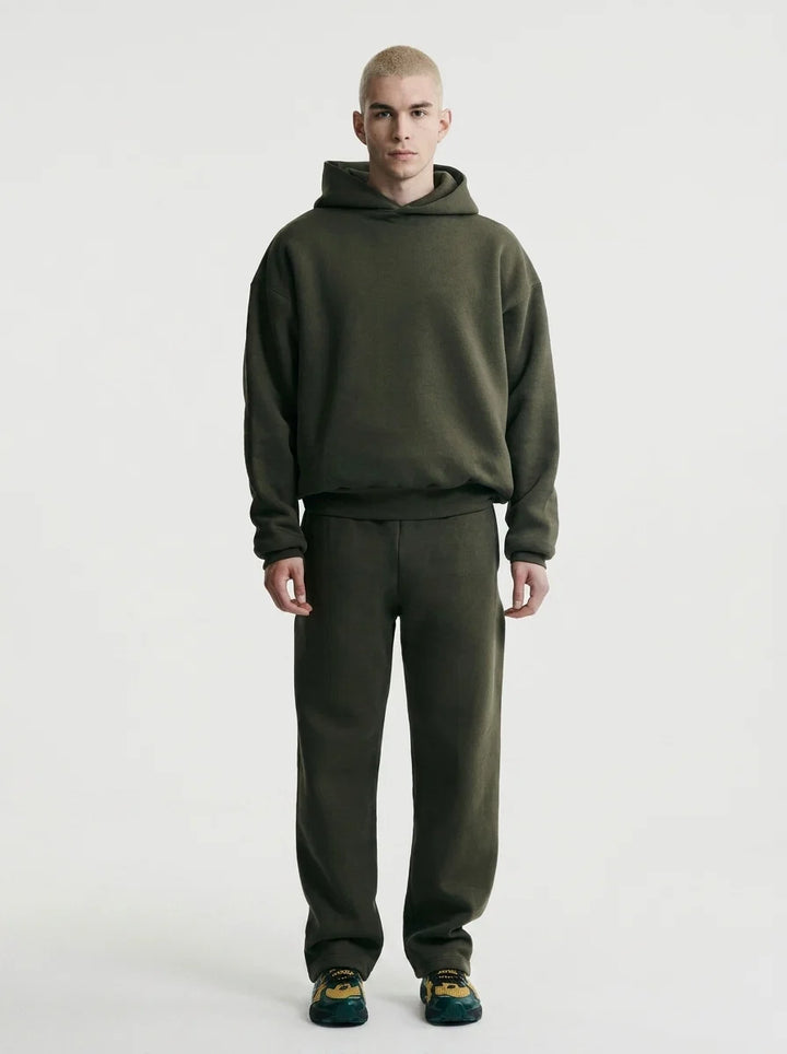 Men's oversized tracksuit in olive green with hooded pullover and matching joggers on model