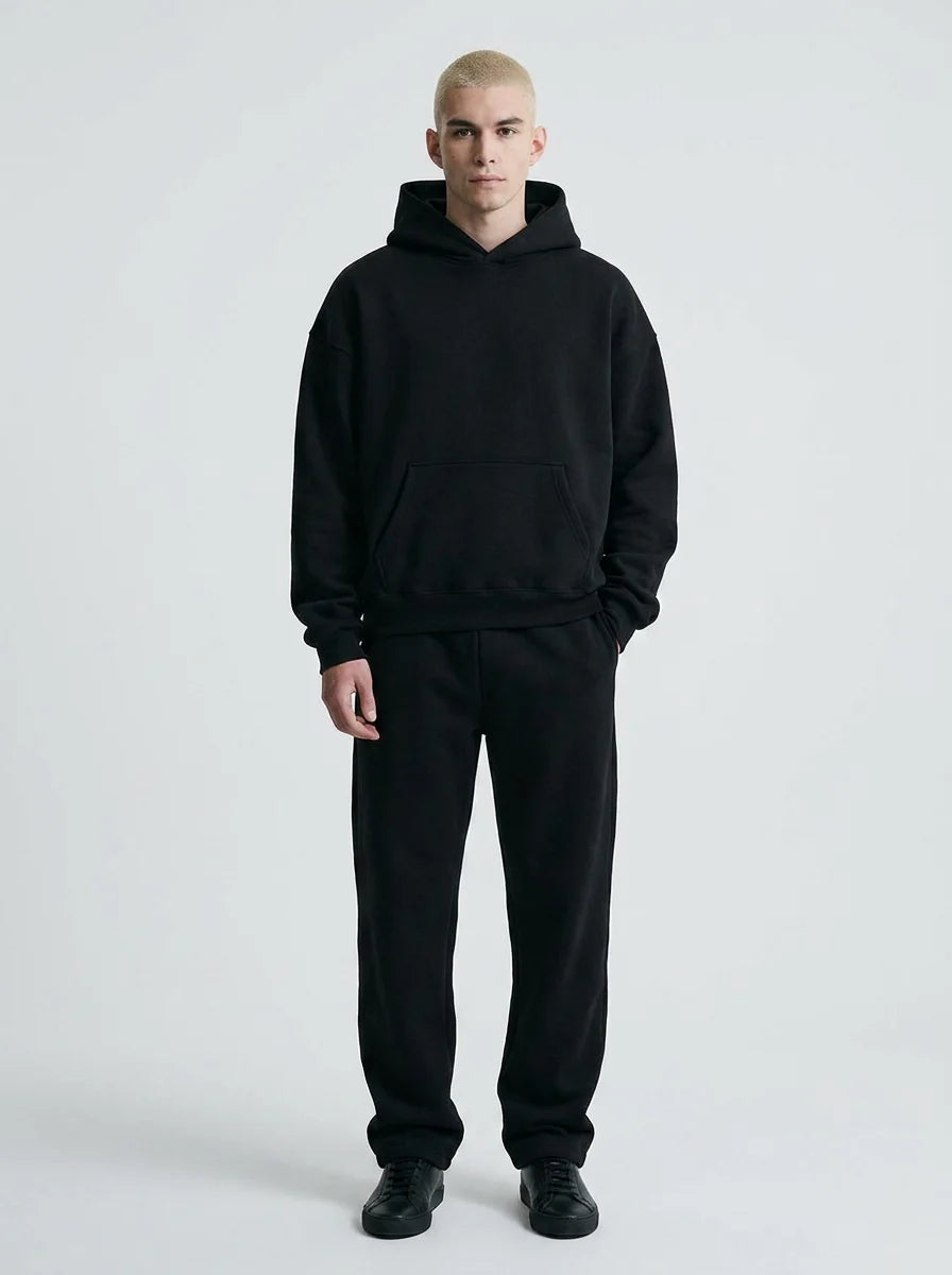 Front view of men's oversized tracksuit showing relaxed hoodie and coordinating trousers