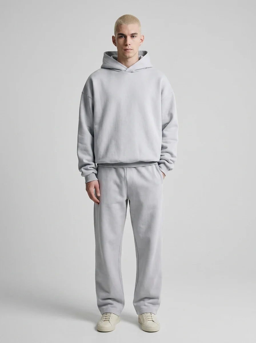 Side view of men's oversized tracksuit displaying relaxed silhouette and straight-leg joggers