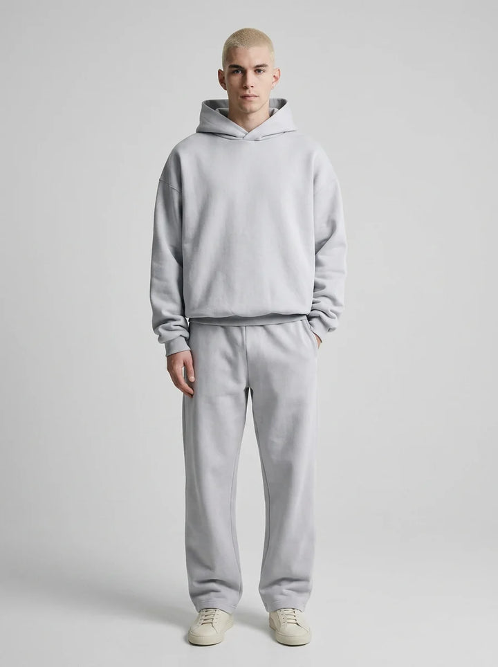 Side view of men's oversized tracksuit displaying relaxed silhouette and straight-leg joggers