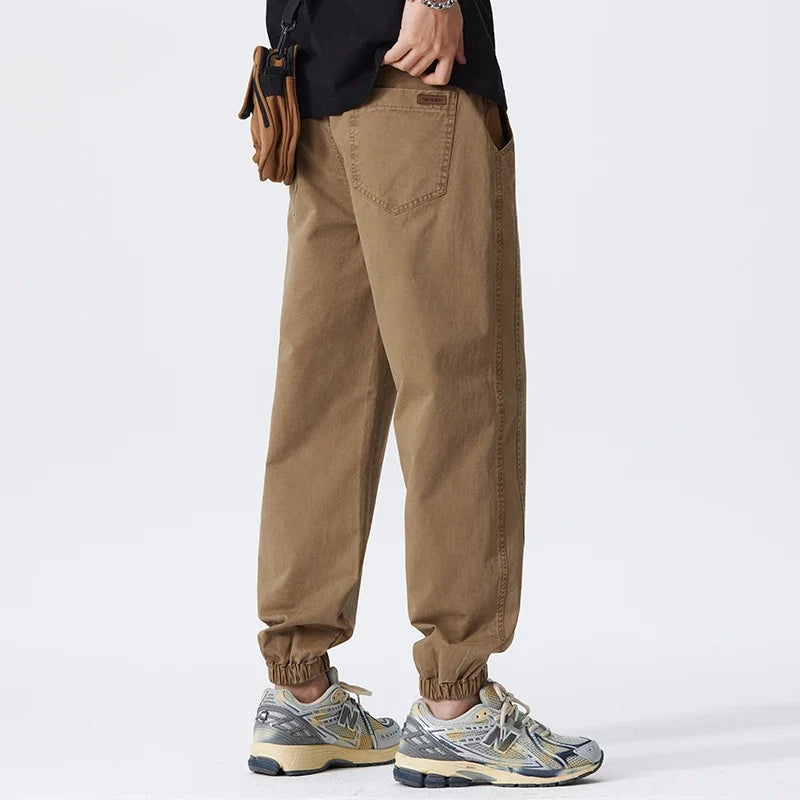 Close-up of elasticated ankle cuffs and side seam detailing on men's casual joggers