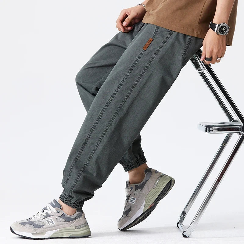 Men's khaki joggers paired with trainers demonstrating relaxed silhouette and everyday styling